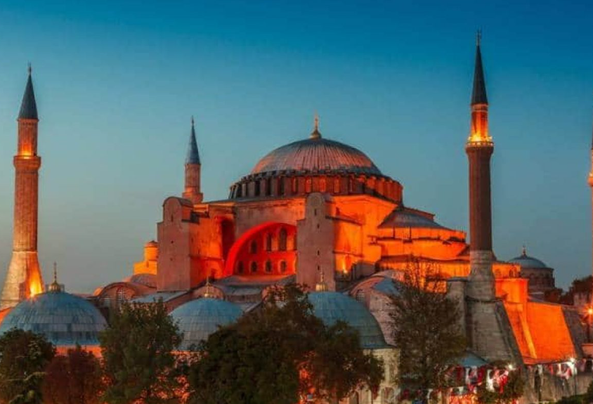 Ramadan di Turki di Bawah Bayang-Bayang Pertempuran Politik Orang-orang berbuka puasa dengan latar belakang Masjid Sultan Ahmed yang ikonik, lebih dikenal sebagai Masjid Biru, dihiasi dengan lampu dan slogan bertuliskan Ramadhan adalah cinta, menandai bulan Ramadhan, di distrik bersejarah Sultan Ahmed di Istanbul, Turki, Selasa (13/4). Ramadhan di Turki di Bawah Bayang-Bayang Pertempuran Politik.