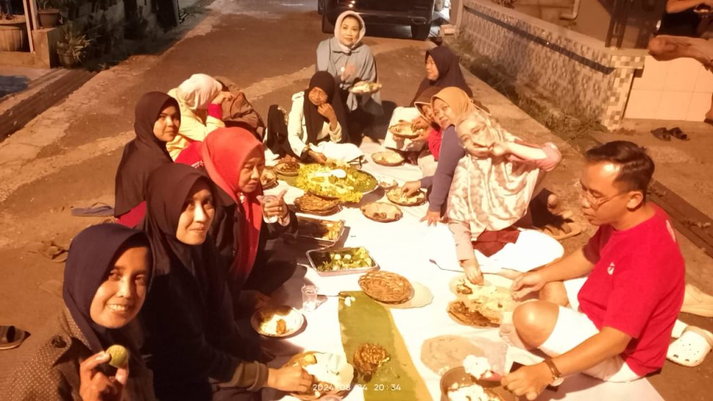 Para Warga Perum As-salam sedang menikmati hidangan di acara makan besar di Perum As-salam Permai.