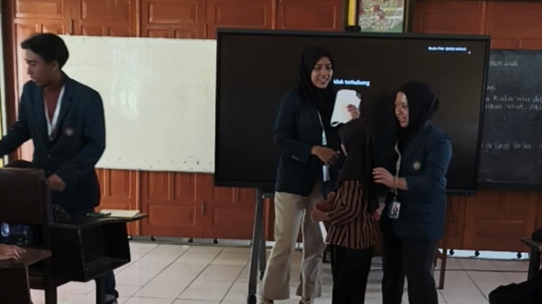 Mahasiswa PKM-Bahari FPIK UB memberikan pemaparan materi gizi ikan dan pemanfaatan media Buku Saku di hadapan siswa SDN 2 Curungrejo.